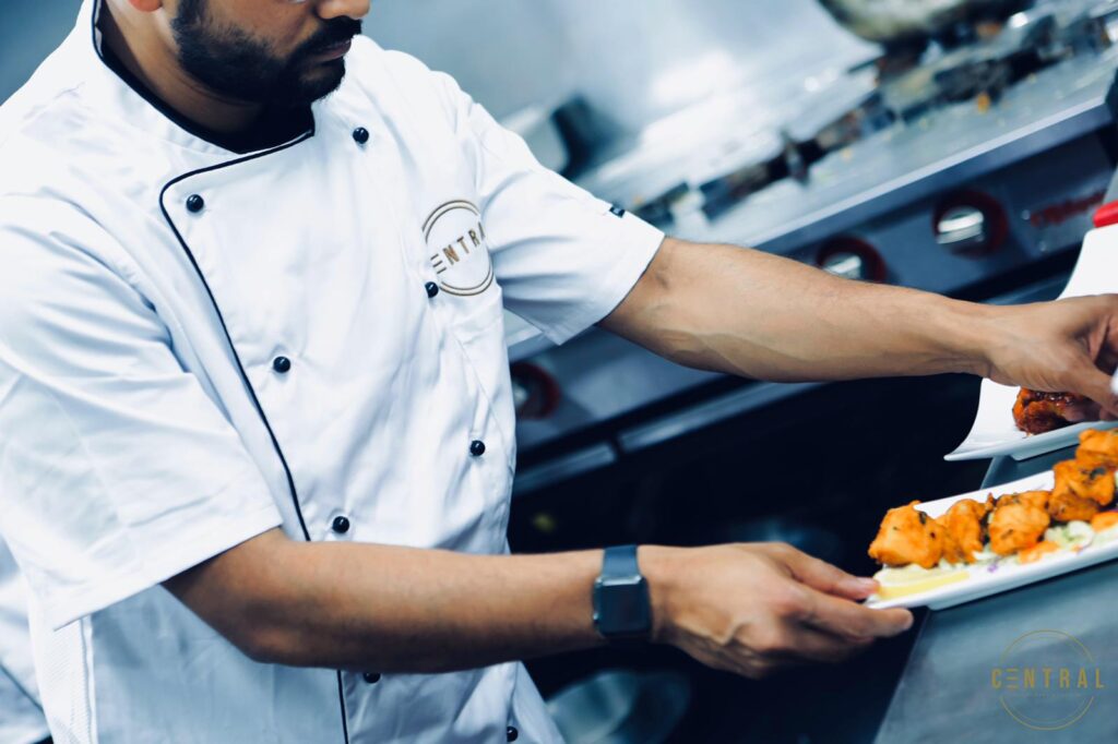 Chef plating a dish in the Central kitchen