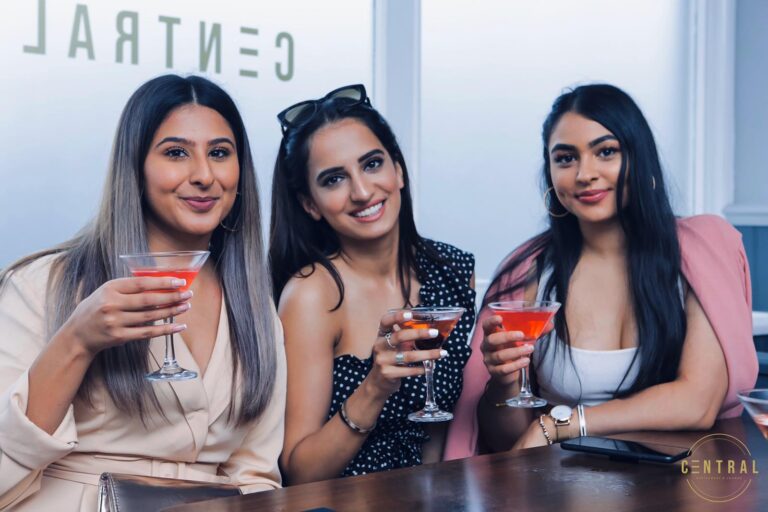 Friends toasting with cocktails at Central