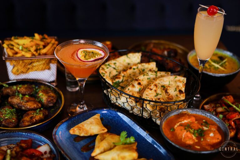 Sharing plates, naan and cocktails on a table