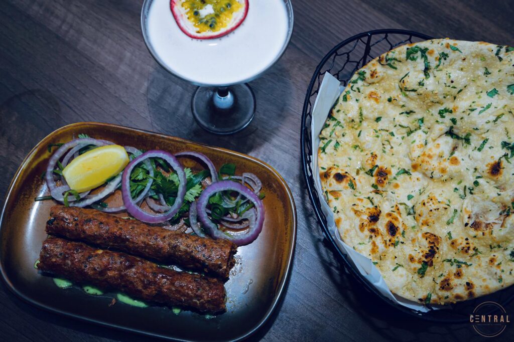 Seekh kebabs with salad and lemon, served with cheese naan