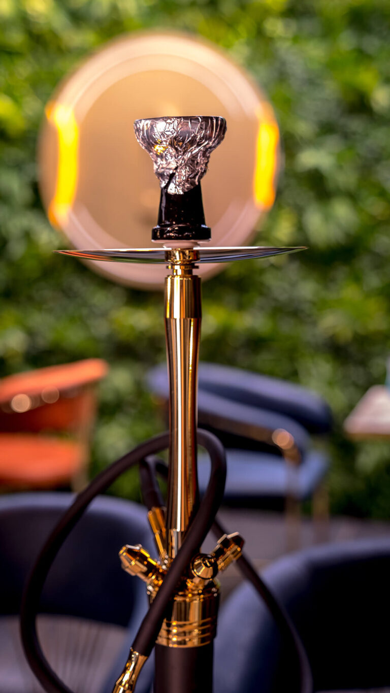 Shisha pipe in front of the lounge green wall