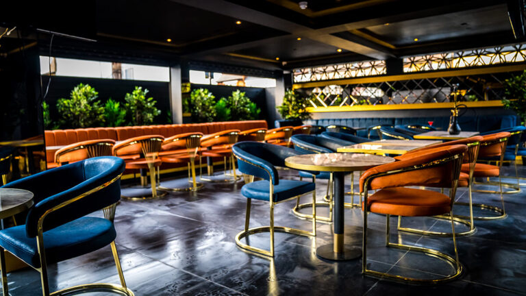 The Shisha Lounge at Central with velvet chairs and a green wall